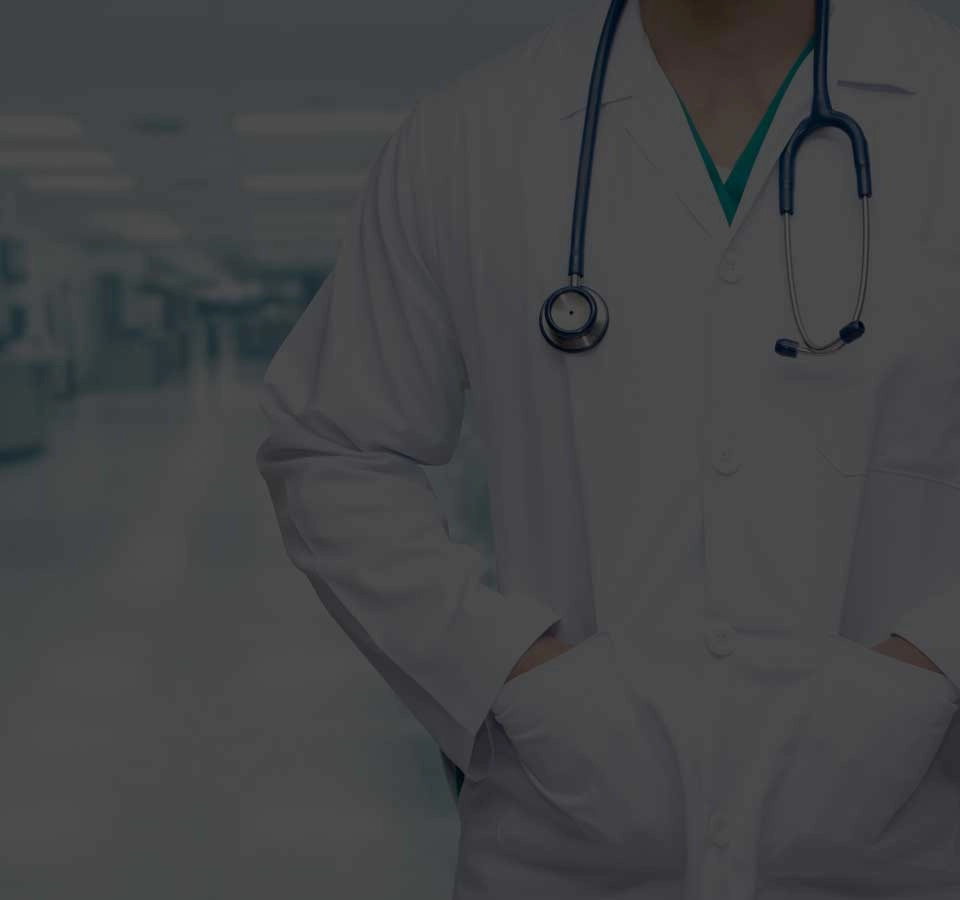 Medical Professional standing with stethoscope and put her hands inside the pocket of hospital uniform